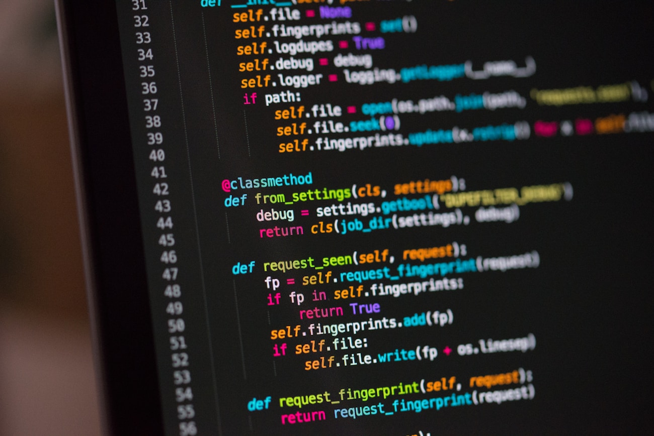 A focused software engineering workspace with code on monitors